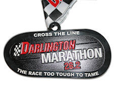 Five inch wide medal in the shape of the race track